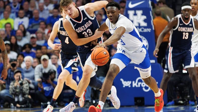 Feb 10, 2024; Lexington, Kentucky, USA; Gonzaga Bulldogs forward Ben Gregg (33) and Kentucky Wildcats guard Adou Thiero (3) chase down the ball during the first half at Rupp Arena at Central Bank Center. Mandatory Credit: Jordan Prather-USA TODAY Sports