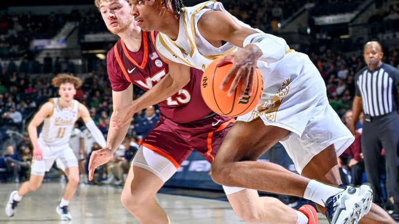 Feb 10, 2024; South Bend, Indiana, USA; Notre Dame Fighting Irish forward Carey Booth (0) dribbles the ball against Virginia Tech Hokies guard Tyler Nickel (23) in the first half at the Purcell Pavilion. Mandatory Credit: Matt Cashore-USA TODAY Sports