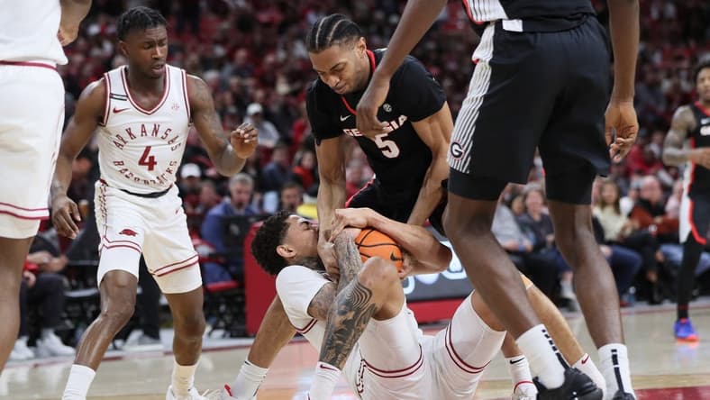 Feb 10, 2024; Fayetteville, Arkansas, USA; Arkansas Razorbacks forward Jalen Graham (11) and Georgia Bulldogs center Frank Anselem-Ibe (5) wrestle for possession during the first half at Bud Walton Arena. Mandatory Credit: Nelson Chenault-USA TODAY Sports