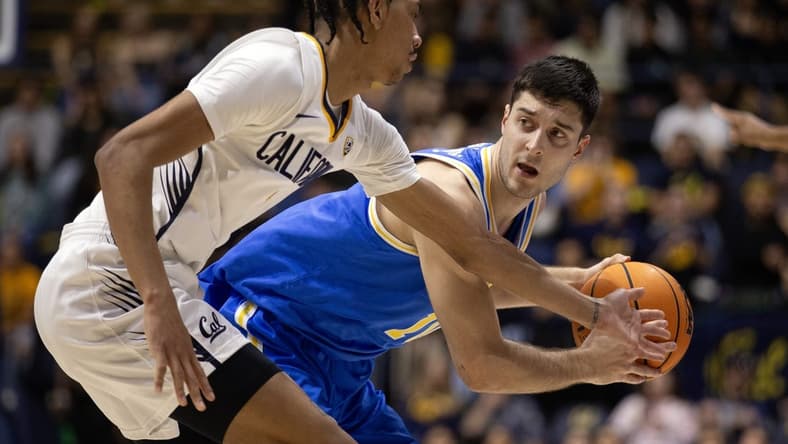 Feb 10, 2024; Berkeley, California, USA; UCLA Bruins guard Lazar Stefanovic (right) looks to pass around California Golden Bears guard Rodney Brown Jr. (1) during the first half at Haas Pavilion. Mandatory Credit: D. Ross Cameron-USA TODAY Sports