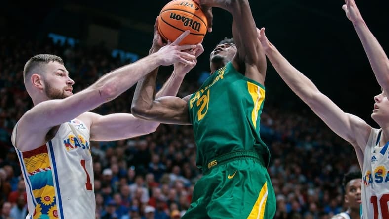 Feb 10, 2024; Lawrence, Kansas, USA; Baylor Bears center Yves Missi (21) gets tangled up with Kansas Jayhawks center Hunter Dickinson (1) under the basket during the first half at Allen Fieldhouse. Mandatory Credit: William Purnell-USA TODAY Sports