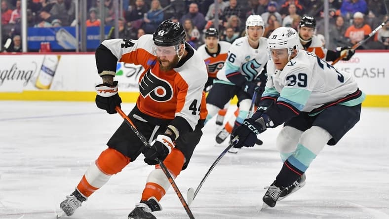 Feb 10, 2024; Philadelphia, Pennsylvania, USA; Philadelphia Flyers left wing Nicolas Deslauriers (44) is defended by Seattle Kraken defenseman Ryker Evans (39) during the first period at Wells Fargo Center. Mandatory Credit: Eric Hartline-USA TODAY Sports