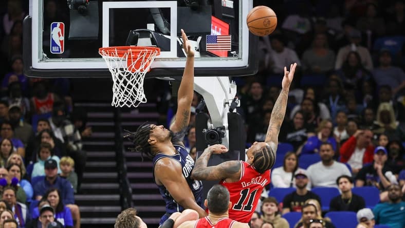 Feb 10, 2024; Orlando, Florida, USA; Chicago Bulls forward DeMar DeRozan (11) goes to the basket against Orlando Magic center Wendell Carter Jr. (34) during the second quarter at KIA Center. Mandatory Credit: Mike Watters-USA TODAY Sports