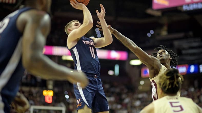 Feb 10, 2024; Tallahassee, Florida, USA; Virginia Cavaliers guard Isaac McKneely (11) shoots the ball over Florida State Seminoles forward Jamir Watkins (2) during the first half at Donald L. Tucker Center. Mandatory Credit: Melina Myers-USA TODAY Sports