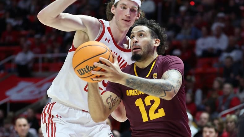 Feb 10, 2024; Salt Lake City, Utah, USA; Arizona State Sun Devils guard Jose Perez (12) goes to the basket against Utah Utes center Branden Carlson (35) during the first half at Jon M. Huntsman Center. Mandatory Credit: Rob Gray-USA TODAY Sports