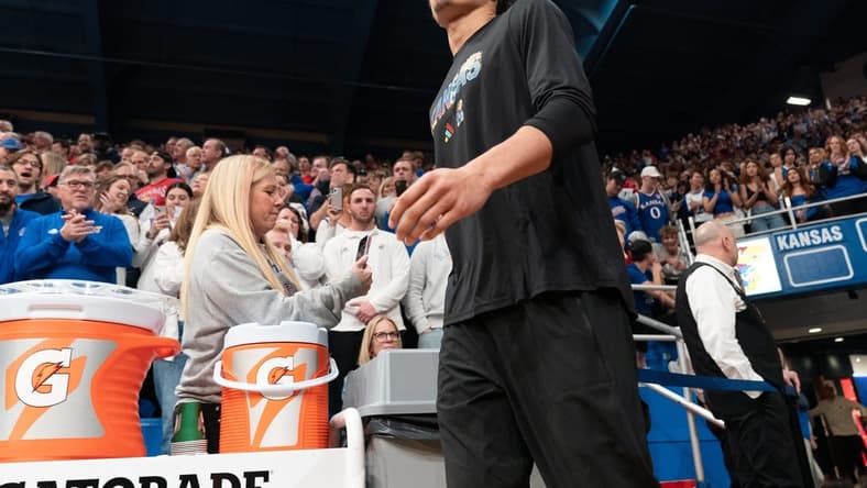 Kansas graduate senior guard Kevin McCullar Jr. (15) walks on to the court before the Jayhawks take on Baylor inside Allen Fieldhouse Saturday, February 10, 2024. McCullar did not play due to injury.