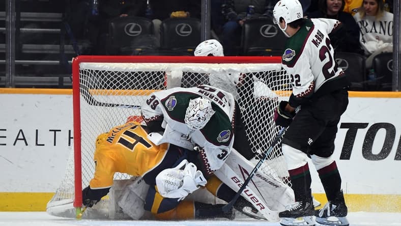 Feb 10, 2024; Nashville, Tennessee, USA; Nashville Predators right wing Michael McCarron (47) draws a penalty as he is hit into Arizona Coyotes goaltender Connor Ingram (39) by center Jack McBain (22) during the second period at Bridgestone Arena. Mandatory Credit: Christopher Hanewinckel-USA TODAY Sports