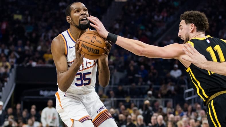 Feb 10, 2024; San Francisco, California, USA; Phoenix Suns forward Kevin Durant (35) is defended by Golden State Warriors guard Klay Thompson (11) during the first half at Chase Center. Mandatory Credit: John Hefti-USA TODAY Sports