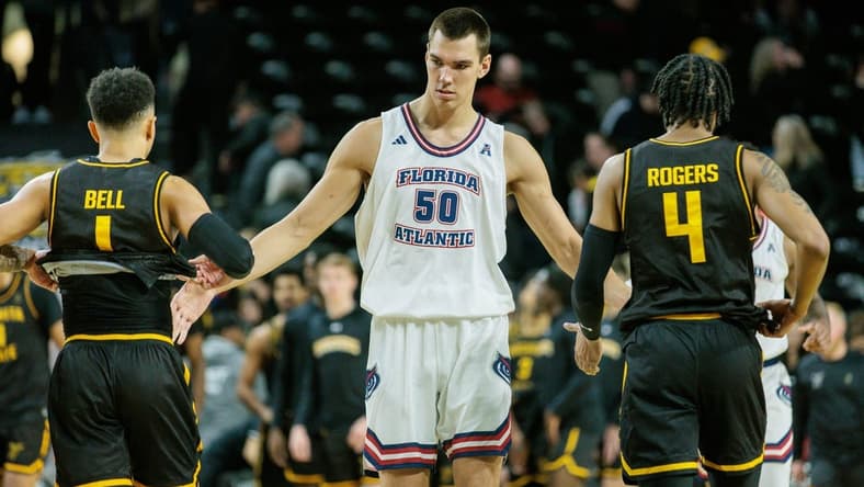Feb 11, 2024; Wichita, Kansas, USA; Florida Atlantic Owls center Vladislav Goldin (50) slaps hands with Wichita State Shockers guard Xavier Bell (1) and Wichita State Shockers guard Colby Rogers (4) after the game at Charles Koch Arena. Mandatory Credit: William Purnell-USA TODAY Sports