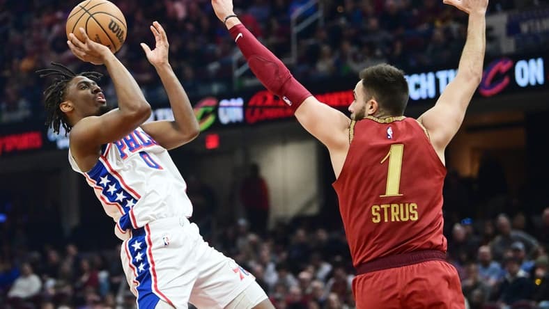 Feb 12, 2024; Cleveland, Ohio, USA; Philadelphia 76ers guard Tyrese Maxey (0) shoots over the defense of  Cleveland Cavaliers guard Max Strus (1) during the first half at Rocket Mortgage FieldHouse. Mandatory Credit: Ken Blaze-USA TODAY Sports
