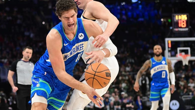 Feb 12, 2024; Milwaukee, Wisconsin, USA; Milwaukee Bucks center Brook Lopez (11) tries to get past Denver Nuggets center Nikola Jokic (15) in the first quarter at Fiserv Forum. Mandatory Credit: Benny Sieu-USA TODAY Sports
