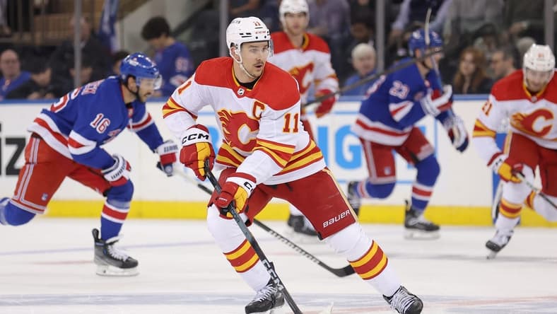 Feb 12, 2024; New York, New York, USA; Calgary Flames center Mikael Backlund (11) skates with the puck against the New York Rangers during the second period at Madison Square Garden. Mandatory Credit: Brad Penner-USA TODAY Sports