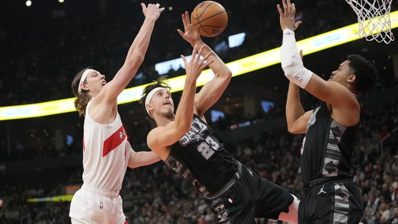 Feb 12, 2024; Toronto, Ontario, CAN; Toronto Raptors forward Kelly Olynyk (41) and San Antonio Spurs forward Zach Collins (23) and forward Keldon Johnson (3) battle for a rebound during the first half at Scotiabank Arena. Mandatory Credit: John E. Sokolowski-USA TODAY Sports