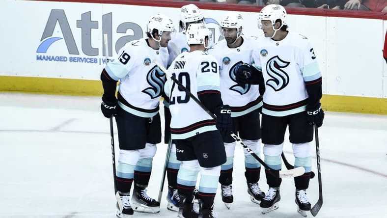 Feb 12, 2024; Newark, New Jersey, USA; Seattle Kraken defenseman Will Borgen (3) celebrates with teammates after scoring a goal against the New Jersey Devils during the third period at Prudential Center. Mandatory Credit: John Jones-USA TODAY Sports