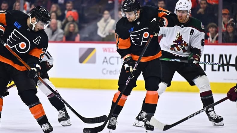 Feb 12, 2024; Philadelphia, Pennsylvania, USA; Philadelphia Flyers right wing Travis Konecny (11) reaches for a loose puck against the Arizona Coyotes in the third period at Wells Fargo Center. Mandatory Credit: Kyle Ross-USA TODAY Sports