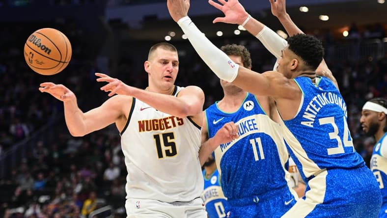 Feb 12, 2024; Milwaukee, Wisconsin, USA; Denver Nuggets center Nikola Jokic (15) passes against Milwaukee Bucks forward Giannis Antetokounmpo (34) in the third quarter at Fiserv Forum. Mandatory Credit: Benny Sieu-USA TODAY Sports