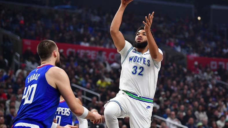 Feb 12, 2024; Los Angeles, California, USA; Minnesota Timberwolves center Karl-Anthony Towns (32) shoots against Los Angeles Clippers center Ivica Zubac (40) during the first half at Crypto.com Arena. Mandatory Credit: Gary A. Vasquez-USA TODAY Sports