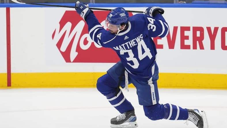 Feb 13, 2024; Toronto, Ontario, CAN; Toronto Maple Leafs forward Auston Matthews (34) shoots the puck during warm up before a game against the St. Louis Blues at Scotiabank Arena. Mandatory Credit: John E. Sokolowski-USA TODAY Sports