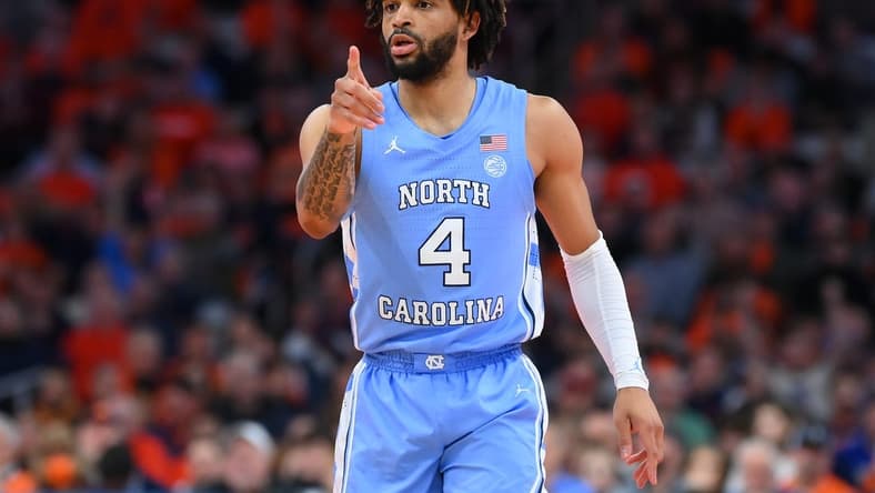Feb 13, 2024; Syracuse, New York, USA; North Carolina Tar Heels guard RJ Davis (4) reacts to a play against the Syracuse Orange during the first half at the JMA Wireless Dome. Mandatory Credit: Rich Barnes-USA TODAY Sports