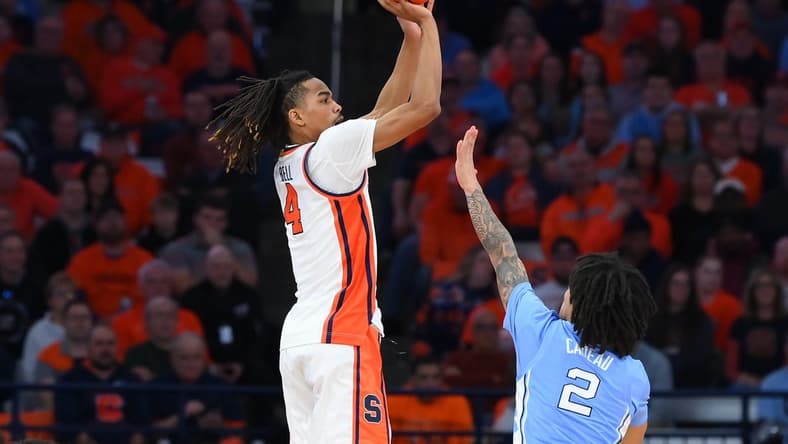 Feb 13, 2024; Syracuse, New York, USA; Syracuse Orange forward Chris Bell (4) shoots the ball against the defense of North Carolina Tar Heels guard Elliot Cadeau (2) during the first half at the JMA Wireless Dome. Mandatory Credit: Rich Barnes-USA TODAY Sports