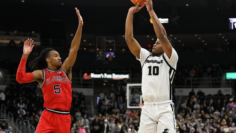 Feb 13, 2024; Providence, Rhode Island, USA; Providence Friars forward Rich Barron (10) shoots the ball over St. John's Red Storm guard Daniss Jenkins (5) during the first half at Amica Mutual Pavilion. Mandatory Credit: Eric Canha-USA TODAY Sports