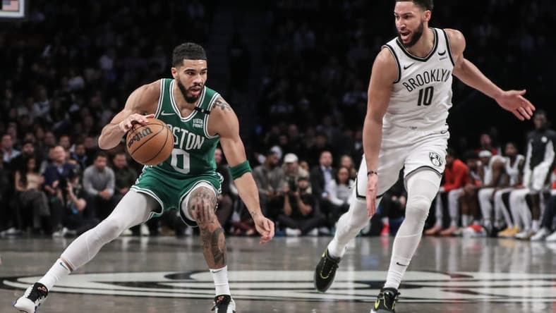 Feb 13, 2024; Brooklyn, New York, USA; Boston Celtics forward Jayson Tatum (0) looks to drive past Brooklyn Nets guard Ben Simmons (10) in the second quarter at Barclays Center. Mandatory Credit: Wendell Cruz-USA TODAY Sports