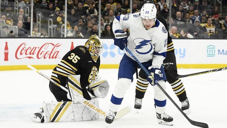 Feb 13, 2024; Boston, Massachusetts, USA; Tampa Bay Lightning center Michael Eyssimont (23) looks for the loose puck in front of Boston Bruins goaltender Linus Ullmark (35) during the second period at TD Garden. Mandatory Credit: Bob DeChiara-USA TODAY Sports