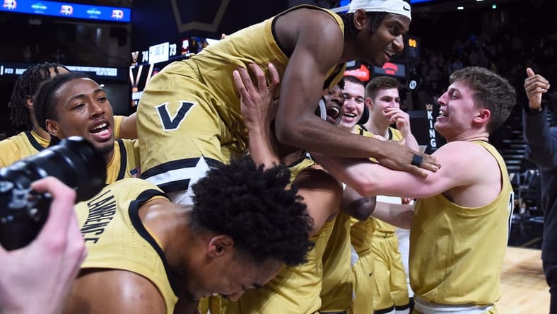 Feb 13, 2024; Nashville, Tennessee, USA; Vanderbilt Commodores guard Ezra Manjon (5) celebrates with teammates after making the game-winning basket against the Texas A&M Aggies at Memorial Gymnasium. Mandatory Credit: Christopher Hanewinckel-USA TODAY Sports