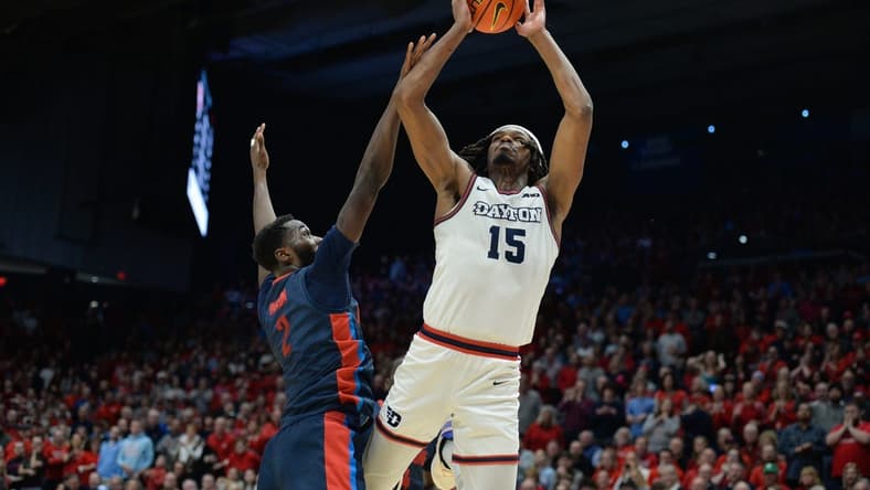 Feb 13, 2024; Dayton, Ohio, USA;  Dayton Flyers forward DaRon Holmes II (15) shoots the ball against Duquesne forward David Dixon (2) during the game at University of Dayton Arena. Mandatory Credit: Matt Lunsford-USA TODAY Sports