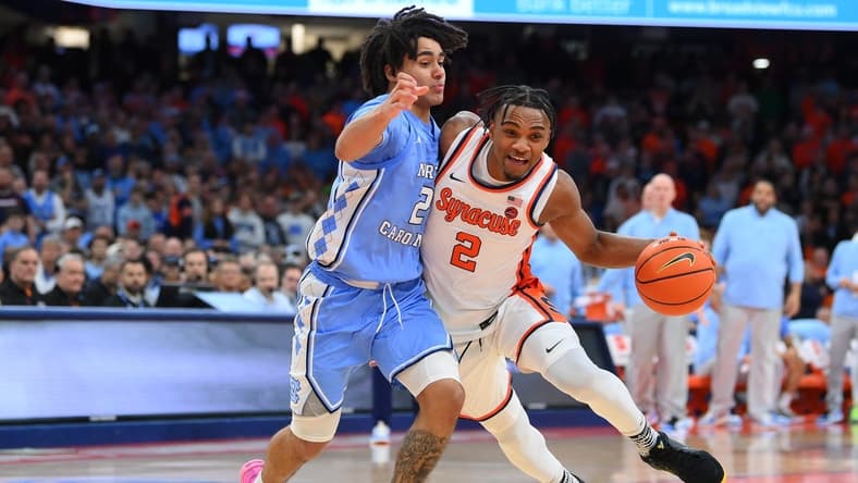 Feb 13, 2024; Syracuse, New York, USA; Syracuse Orange guard JJ Starling (2) drives to the basket as North Carolina Tar Heels guard Elliot Cadeau (2) defends during the second half at the JMA Wireless Dome. Mandatory Credit: Rich Barnes-USA TODAY Sports
