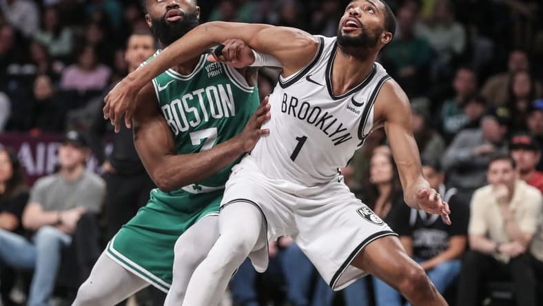 Feb 13, 2024; Brooklyn, New York, USA; Boston Celtics guard Jaylen Brown (7) and Brooklyn Nets forward Mikal Bridges (1) box out for a rebound in the second quarter at Barclays Center. Mandatory Credit: Wendell Cruz-USA TODAY Sports