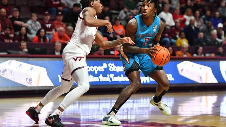 Feb 13, 2024; Blacksburg, Virginia, USA; Florida State Seminoles forward Jamir Watkins (2) looks to pass the ball while being defended by Virginia Tech Hokies guard MJ Collins (2) at Cassell Coliseum. Mandatory Credit: Brian Bishop-USA TODAY Sports