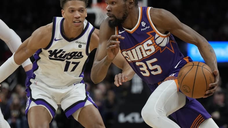 Feb 13, 2024; Phoenix, Arizona, USA; Phoenix Suns forward Kevin Durant (35) drives on Sacramento Kings forward Kessler Edwards (17) in the first half at Footprint Center. Mandatory Credit: Rick Scuteri-USA TODAY Sports