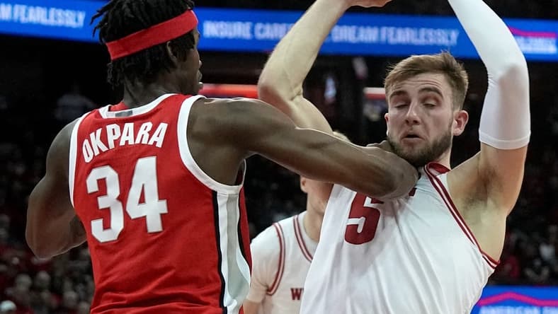 Feb 13, 2024; Madison, Wisconsin, USA;. Ohio State center Felix Okpara (34) grads Wisconsin forward Tyler Wahl (5) during the second half of their game at the Kohl Center. Mandatory Credit: Mark Hoffman/Milwaukee Journal Sentinelf-USA TODAY Sports