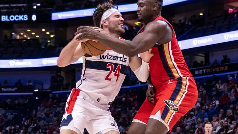 Feb 14, 2024; New Orleans, Louisiana, USA; Washington Wizards forward Corey Kispert (24) dribbles against New Orleans Pelicans forward Zion Williamson (1) during the first half at Smoothie King Center. Mandatory Credit: Stephen Lew-USA TODAY Sports
