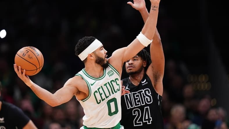 Feb 14, 2024; Boston, Massachusetts, USA; Boston Celtics forward Jayson Tatum (0) looks for an opening against Brooklyn Nets guard Cam Thomas (24) in the second half at TD Garden. Mandatory Credit: David Butler II-USA TODAY Sports