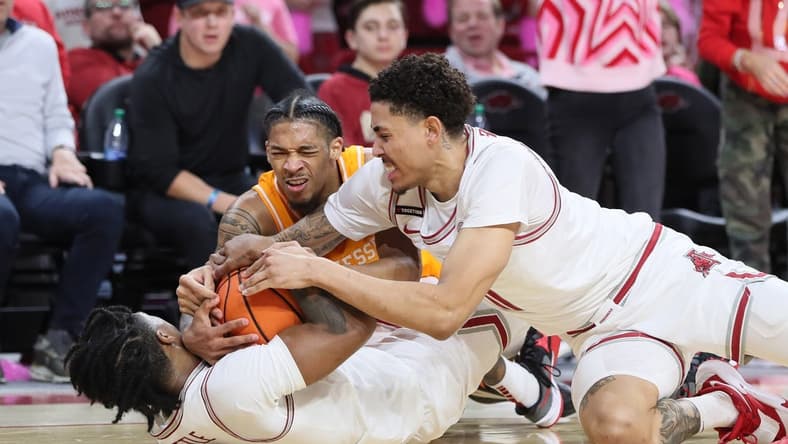 Feb 14, 2024; Fayetteville, Arkansas, USA; Tennessee Volunteers guard Zakai Zeigler (5) fights for a loose ball with Arkansas Razorbacks guard Khalif Battle (0) and forward Jalen Graham (11) during the first half at Bud Walton Arena. Mandatory Credit: Nelson Chenault-USA TODAY Sports