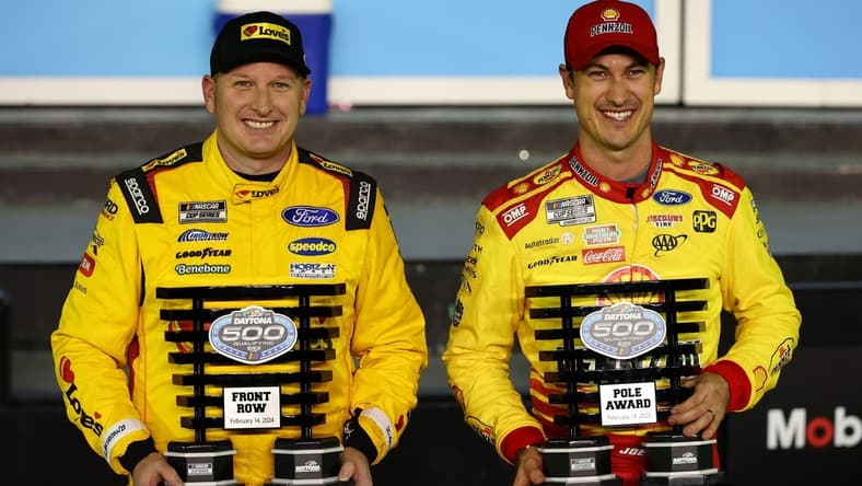 Feb 14, 2024; Daytona Beach, Florida, USA; NASCAR Cup Series driver Joey Logano (right) poses with the pole award with driver Michael McDowell (left), qualified second, after qualifying for the Daytona 500 at Daytona International Speedway. Mandatory Credit: Mark J. Rebilas-USA TODAY Sports