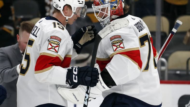 Feb 14, 2024; Pittsburgh, Pennsylvania, USA; Florida Panthers center Anton Lundell (15) and goaltender Sergei Bobrovsky (72) celebrate after defeating the Pittsburgh Penguins at PPG Paints Arena. Florida won 5-2.Mandatory Credit: Charles LeClaire-USA TODAY Sports