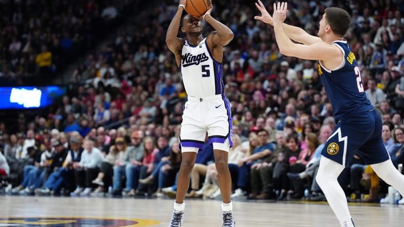 Feb 14, 2024; Denver, Colorado, USA; Sacramento Kings guard De'Aaron Fox (5) shoots the ball over Denver Nuggets guard Collin Gillespie (21) in the second half at Ball Arena. Mandatory Credit: Ron Chenoy-USA TODAY Sports