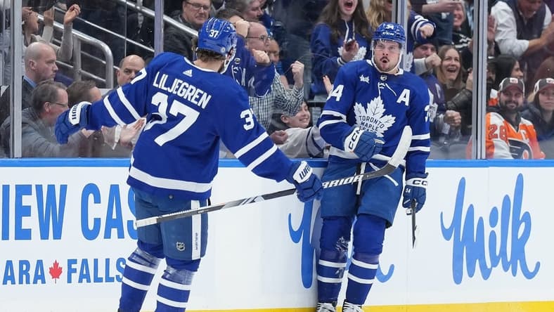 Feb 15, 2024; Toronto, Ontario, CAN; Toronto Maple Leafs center Auston Matthews (34) scores his first goal and celebrates with defenseman Timothy Liljegren (37) against the Philadelphia Flyers during the second period at Scotiabank Arena. Mandatory Credit: Nick Turchiaro-USA TODAY Sports