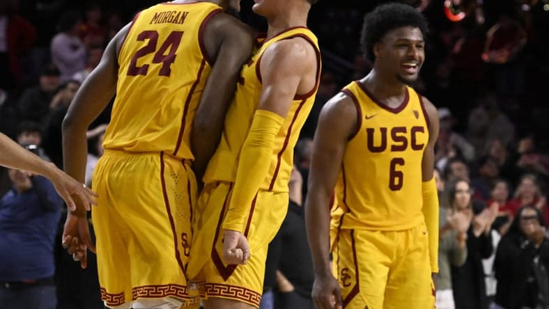 Feb 15, 2024; Los Angeles, California, USA; Southern California Trojans guard Kobe Johnson (center) celebrates with forward Joshua Morgan (24) and guard Bronny James (6) after the Trojans defeat the Utah Utes in a NCAA basketball game at Galen Center. Mandatory Credit: Alex Gallardo-USA TODAY Sports