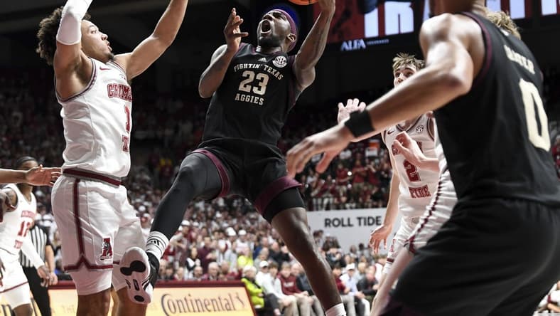 Feb 17, 2024; Tuscaloosa, Alabama, USA; Texas A&M Aggies guard Tyrece Radford (23) shoots in the lane against Alabama Crimson Tide guard Mark Sears (1) during the first half at Coleman Coliseum. Mandatory Credit: Gary Cosby Jr.-USA TODAY Sports