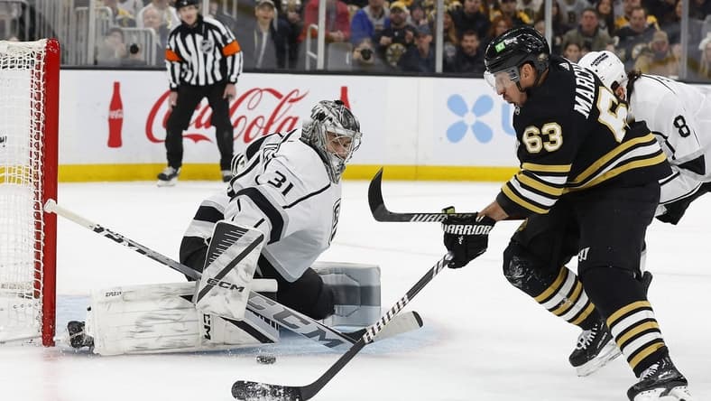 Feb 17, 2024; Boston, Massachusetts, USA; Boston Bruins left wing Brad Marchand (63) goes for a rebound in front of Los Angeles Kings goaltender David Rittich (31) during the first period at TD Garden. Mandatory Credit: Winslow Townson-USA TODAY Sports