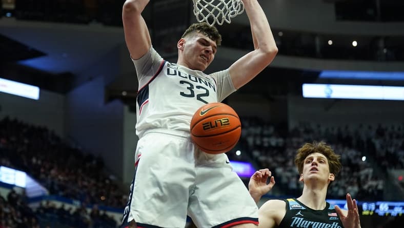 Feb 17, 2024; Hartford, Connecticut, USA; UConn Huskies center Donovan Clingan (32) makes the basket against the Marquette Golden Eagles in the second half at XL Center. Mandatory Credit: David Butler II-USA TODAY Sports