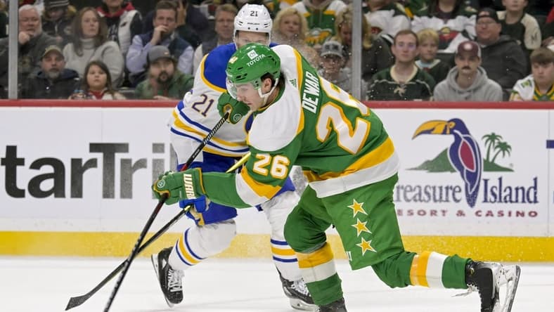 Feb 17, 2024; Saint Paul, Minnesota, USA; Minnesota Wild forward Connor Dewar (26) clears the puck on a penalty kill against the Buffalo Sabres during the first period at Xcel Energy Center. Mandatory Credit: Nick Wosika-USA TODAY Sports