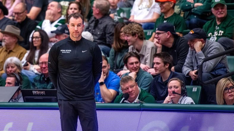 Utah State basketball head coach Danny Sprinkle stares off into the distance after a turnover in a blowout loss against Colorado State at Moby Arena on Saturday, Feb. 17, 2024 in Fort Collins, Colo.