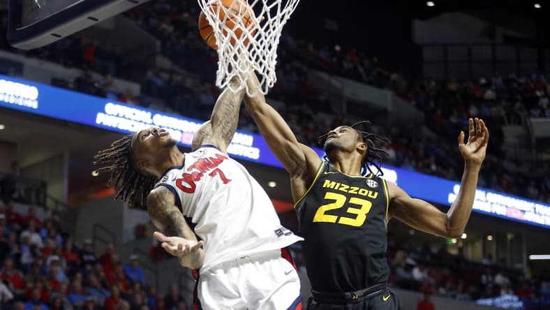 Feb 17, 2024; Oxford, Mississippi, USA; Mississippi Rebels guard Allen Flanigan (7) and Missouri Tigers forward Aidan Shaw (23) battle for a rebound during the first half at The Sandy and John Black Pavilion at Ole Miss. Mandatory Credit: Petre Thomas-USA TODAY Sports