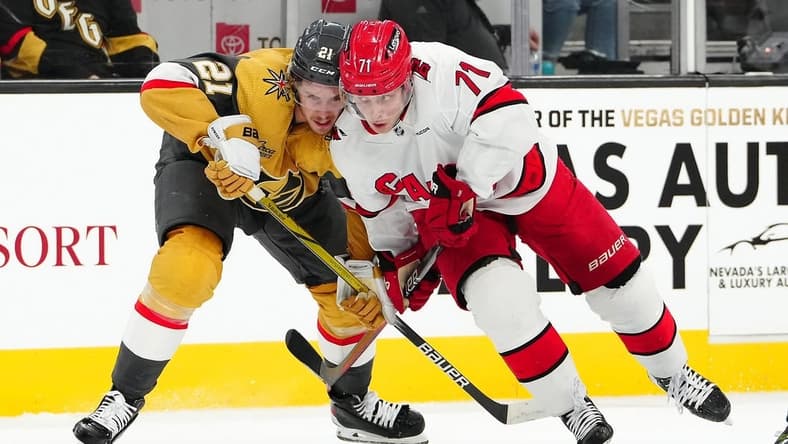 Feb 17, 2024; Las Vegas, Nevada, USA; Vegas Golden Knights center Brett Howden (21) skates against Carolina Hurricanes right wing Jesper Fast (71) during the first period at T-Mobile Arena. Mandatory Credit: Stephen R. Sylvanie-USA TODAY Sports