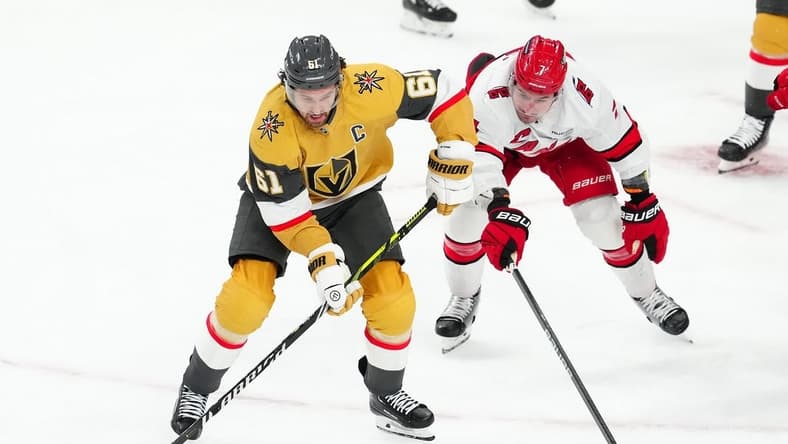 Feb 17, 2024; Las Vegas, Nevada, USA; Vegas Golden Knights right wing Mark Stone (61) skates against Carolina Hurricanes defenseman Dmitry Orlov (7) during the third period at T-Mobile Arena. Mandatory Credit: Stephen R. Sylvanie-USA TODAY Sports